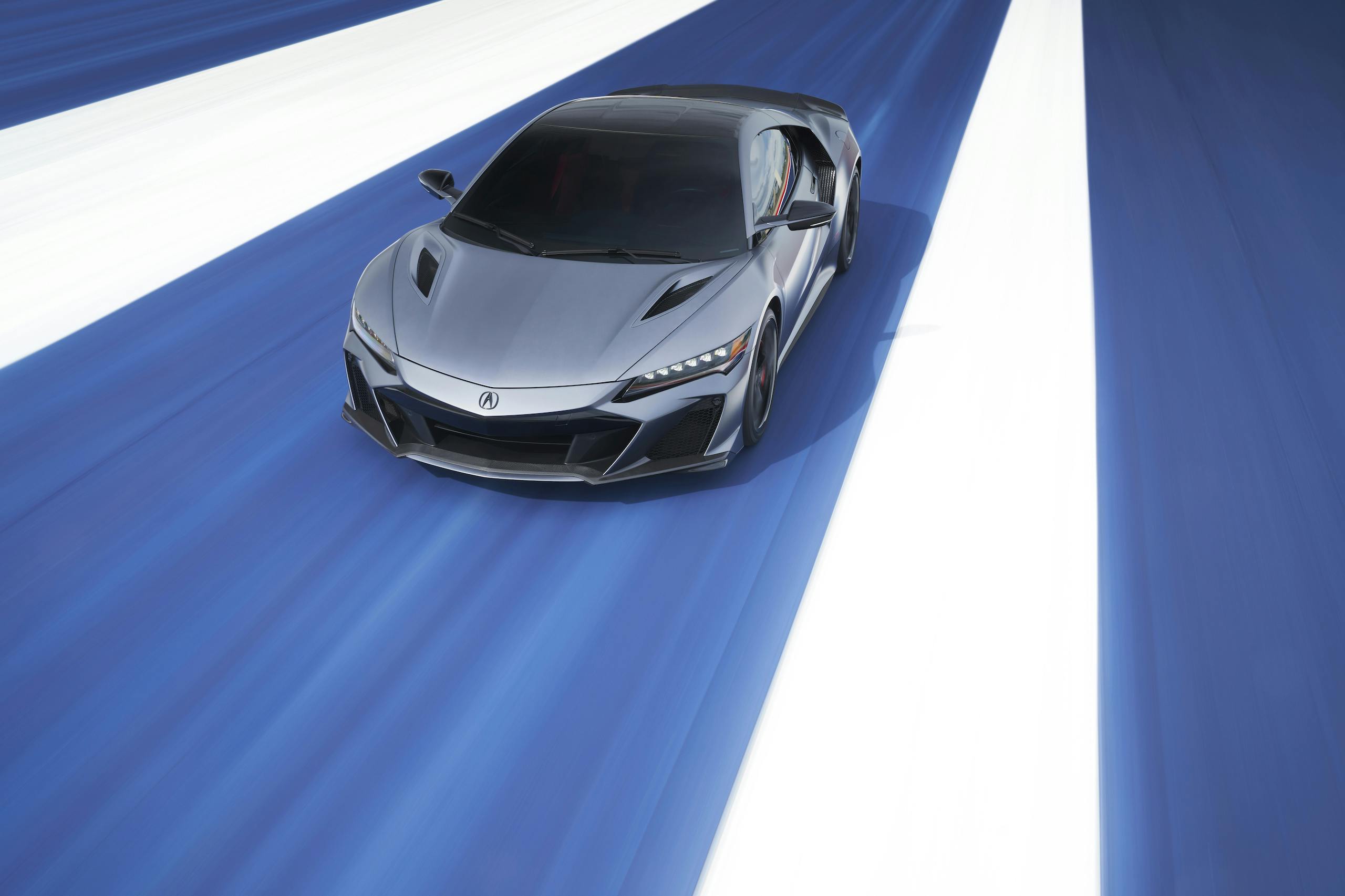 2022 Acura NSX Type S front three-quarter action over blue