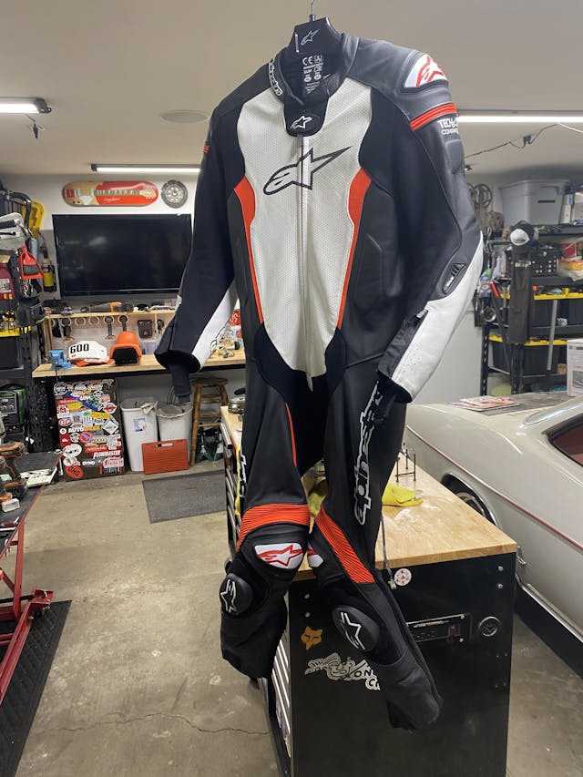 alpinestars suit hanging in garage