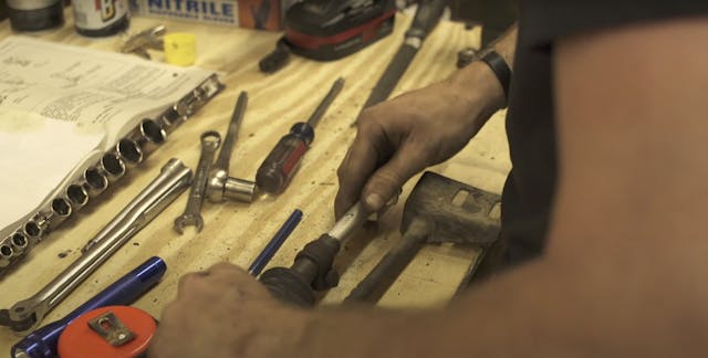 hands repairing corvair shifter