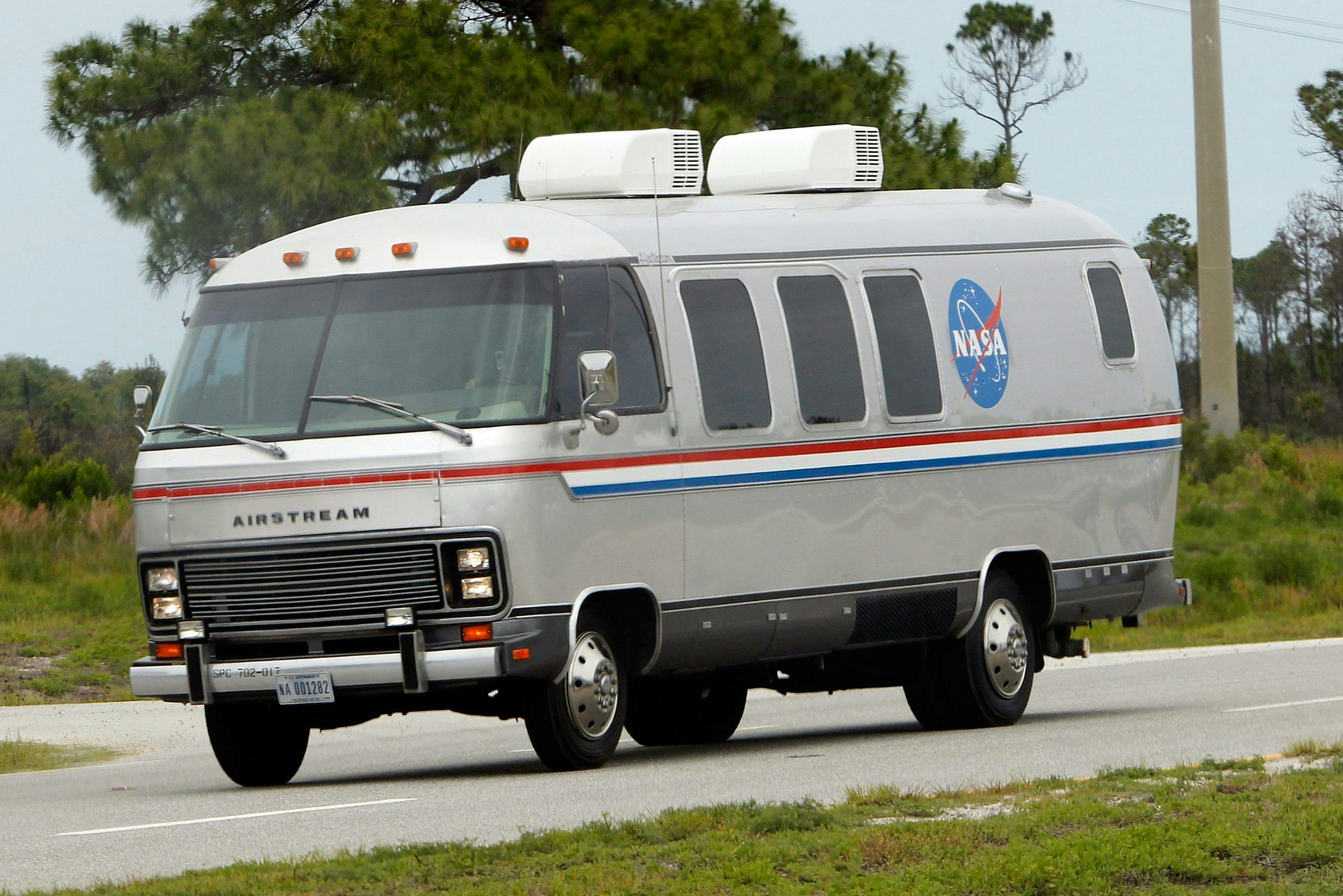 Space Shuttle Discovery astronauts ride in the astrovan