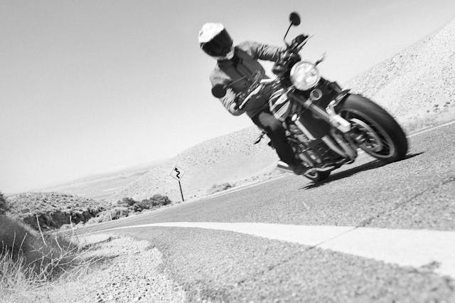 Kawasaki Z900RS rider dynamic action black white