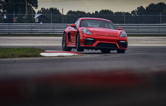 2021 Porsche Cayman GT4 front three-quarter curb hop action