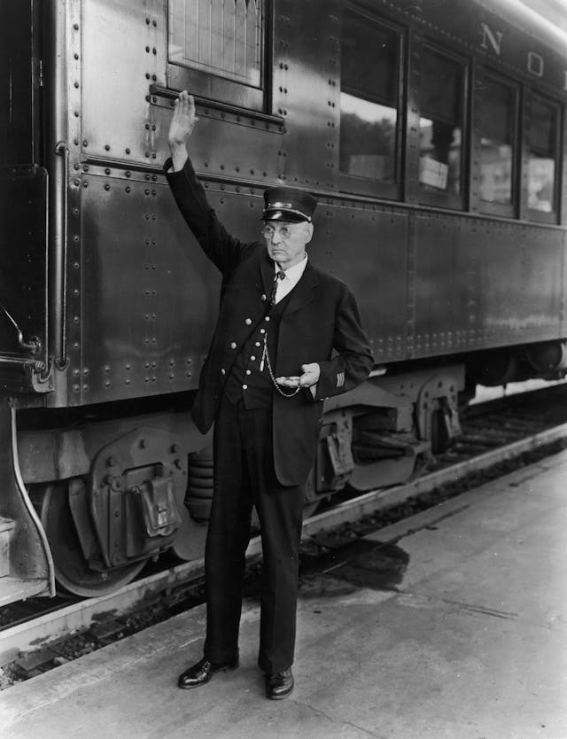 Train Conductor keeping time for departure