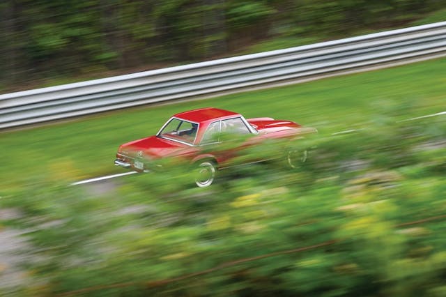 1965 Mercedes 230SL rear three-quarter dynamic action