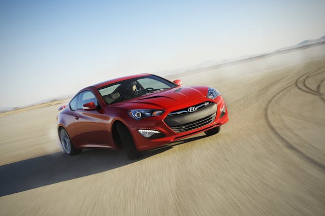 Hyundai 2013 Genesis Coupe front three-quarter slide driving action