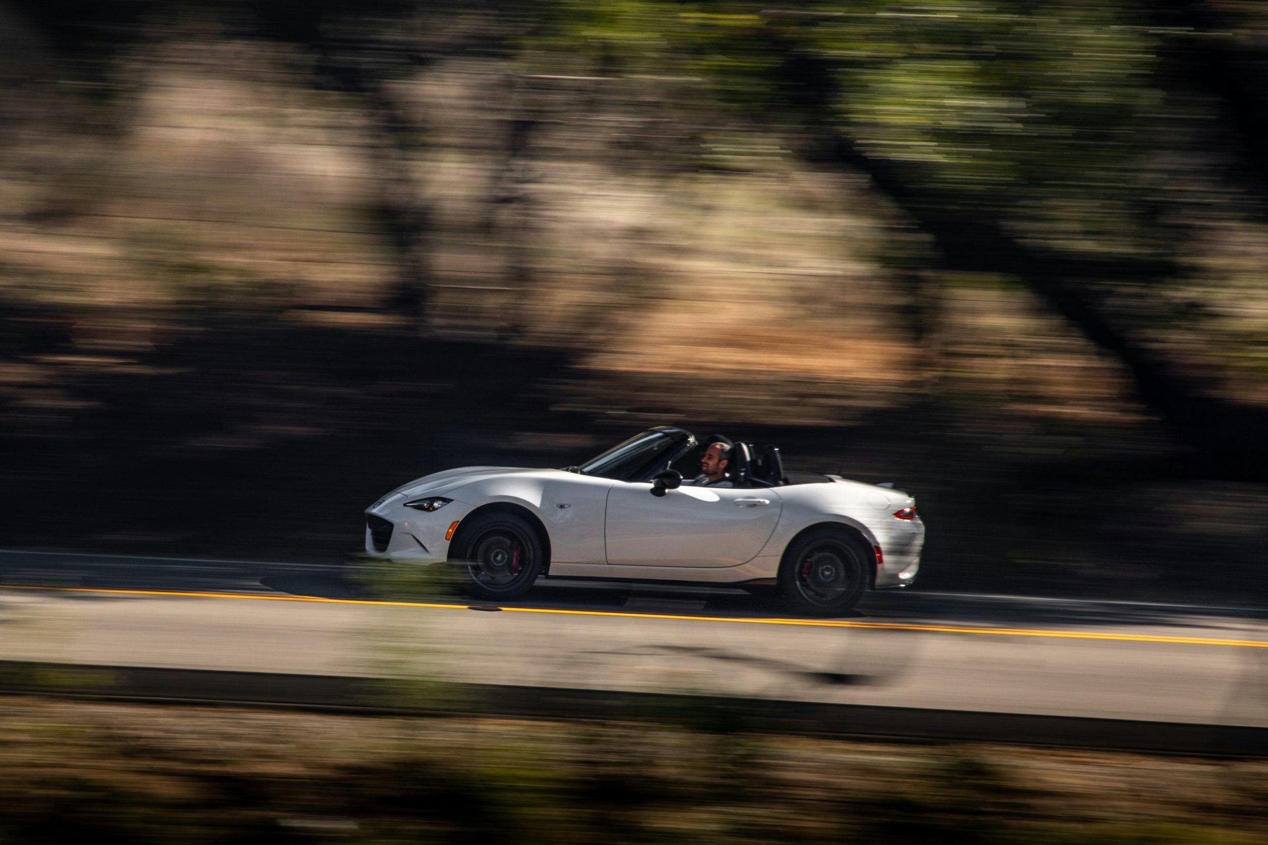 2021 Mazda MX-5 Miata Club Roadster side profile driving blurred