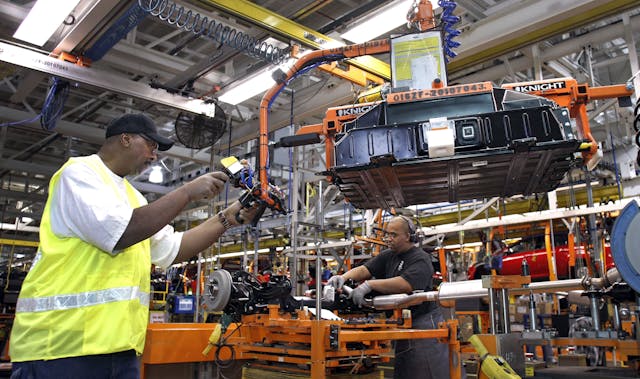 Ford workers installing battery packs assembly line jobs