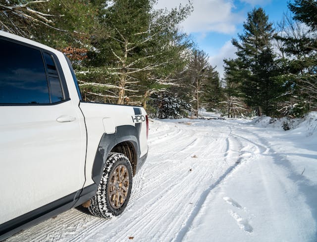 2021 Honda Ridgeline AWD Sport bed wheel and decals on snowy path