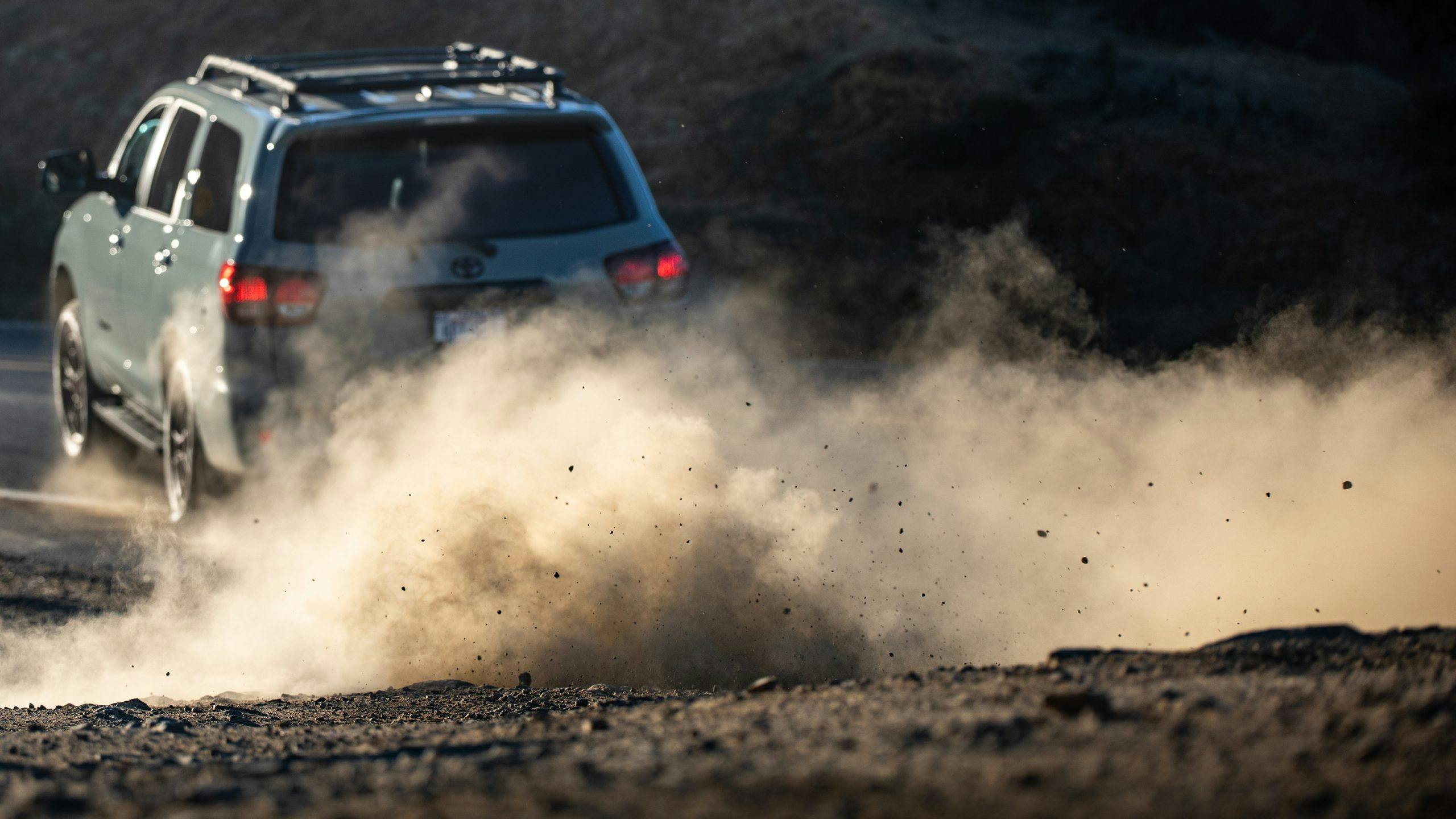 2022 Toyota Sequoia TRD Pro rear three-quarter dust cloud action