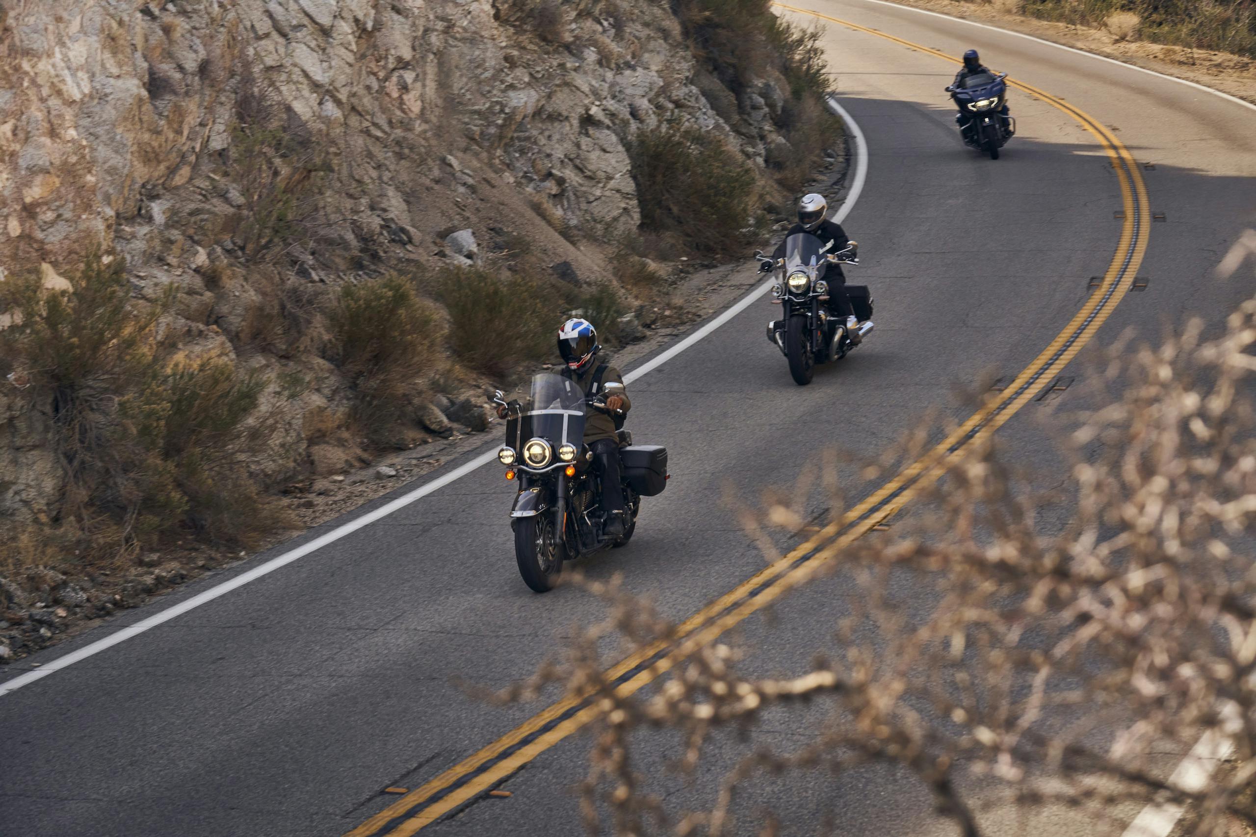 cruiser motos rider group front riding action high angle