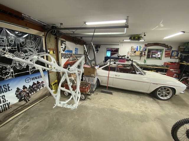 XR250R frame hanging in garage with Corvair