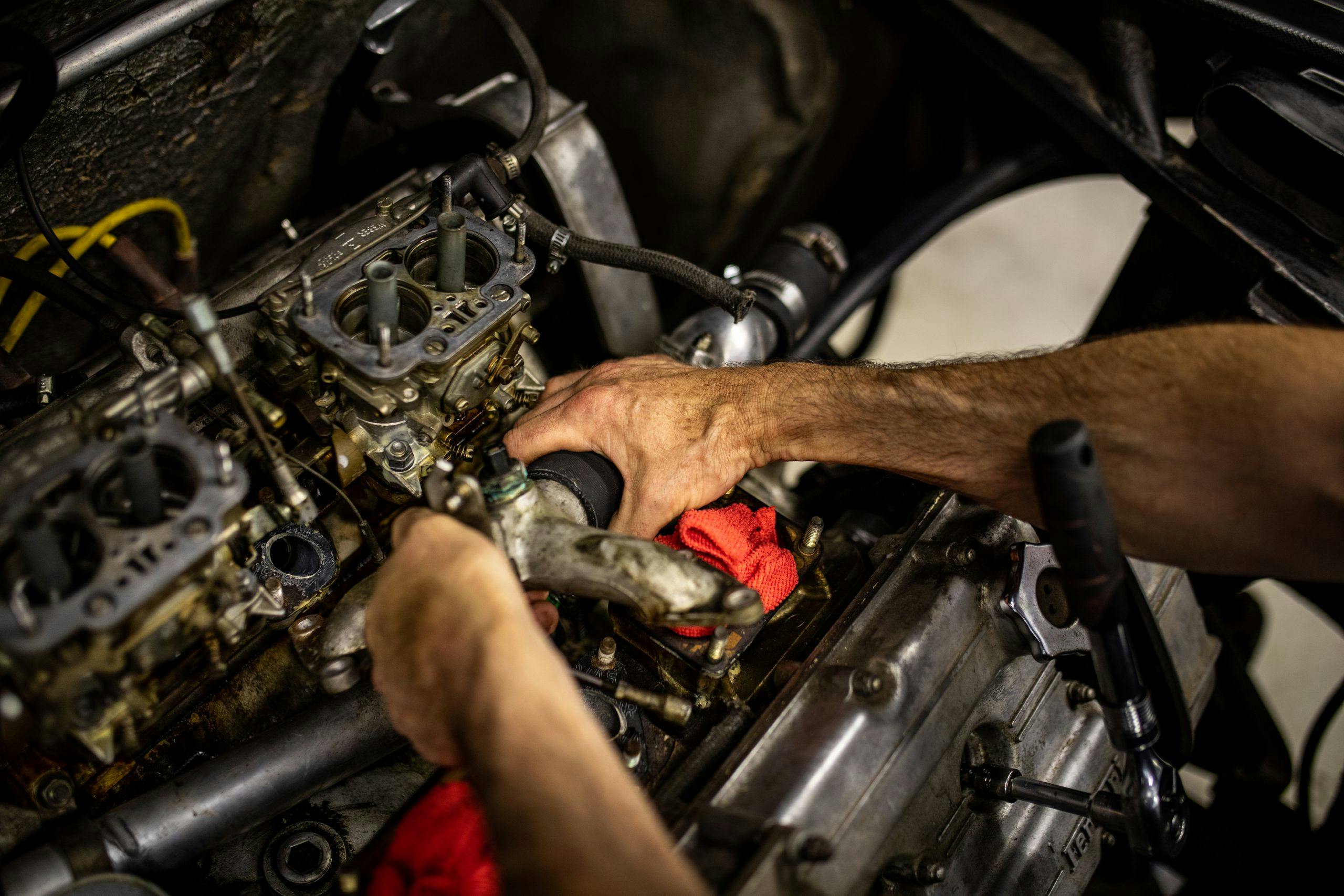 Ferrari Dino restoration engine hands working detail
