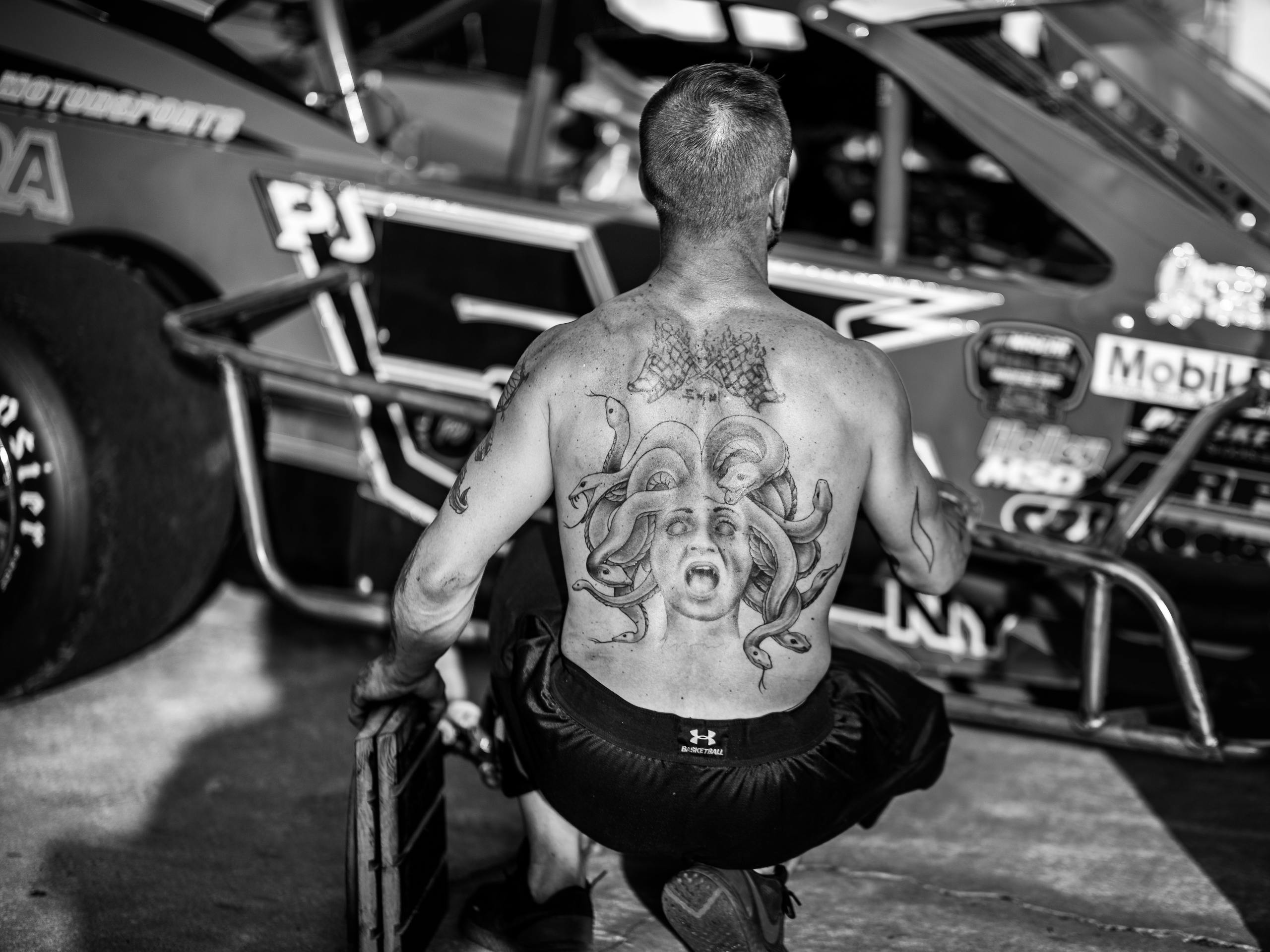 Grassroots racing atmosphere medusa back tattoo patron