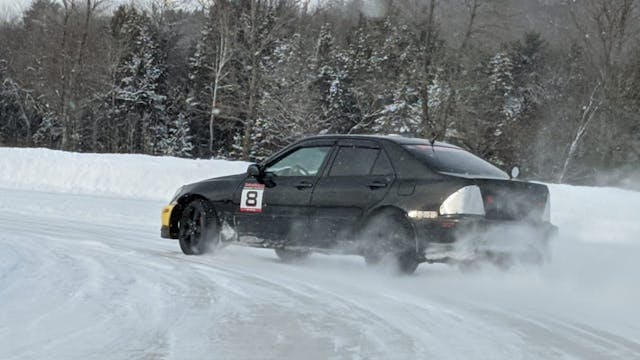 car drifts around corner in ice race