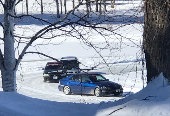 three cars participate in an ice race