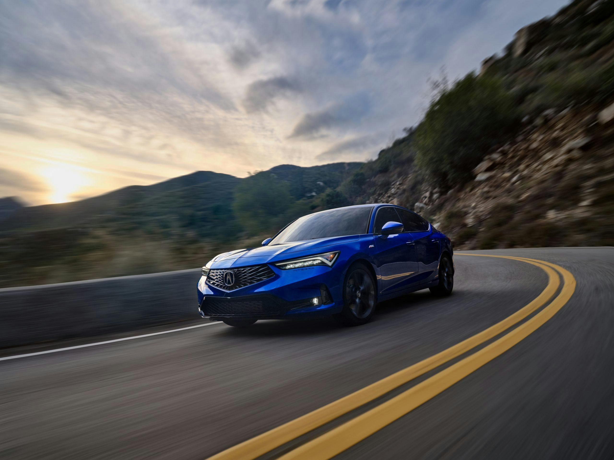 2023 Acura Integra exterior blue driving front three-quarter