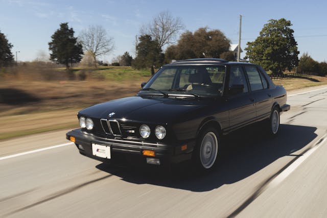 BMW E28 M5 front three-quarter driving action
