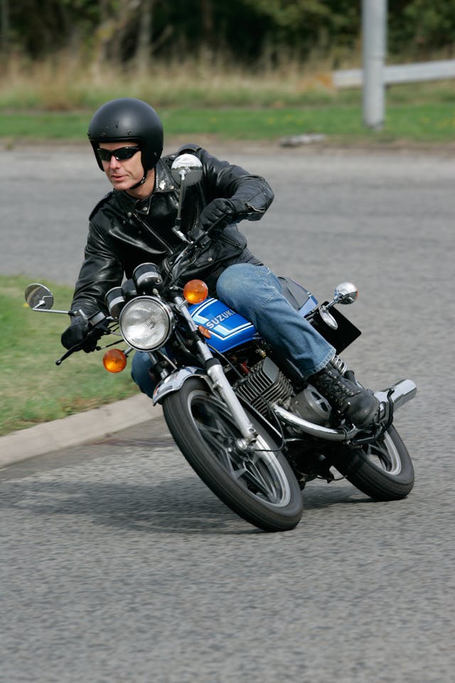 Suzuki GT250 X7 riding action vertical