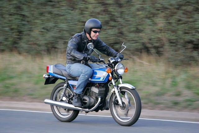 Suzuki GT250 X7 riding action front three-quarter