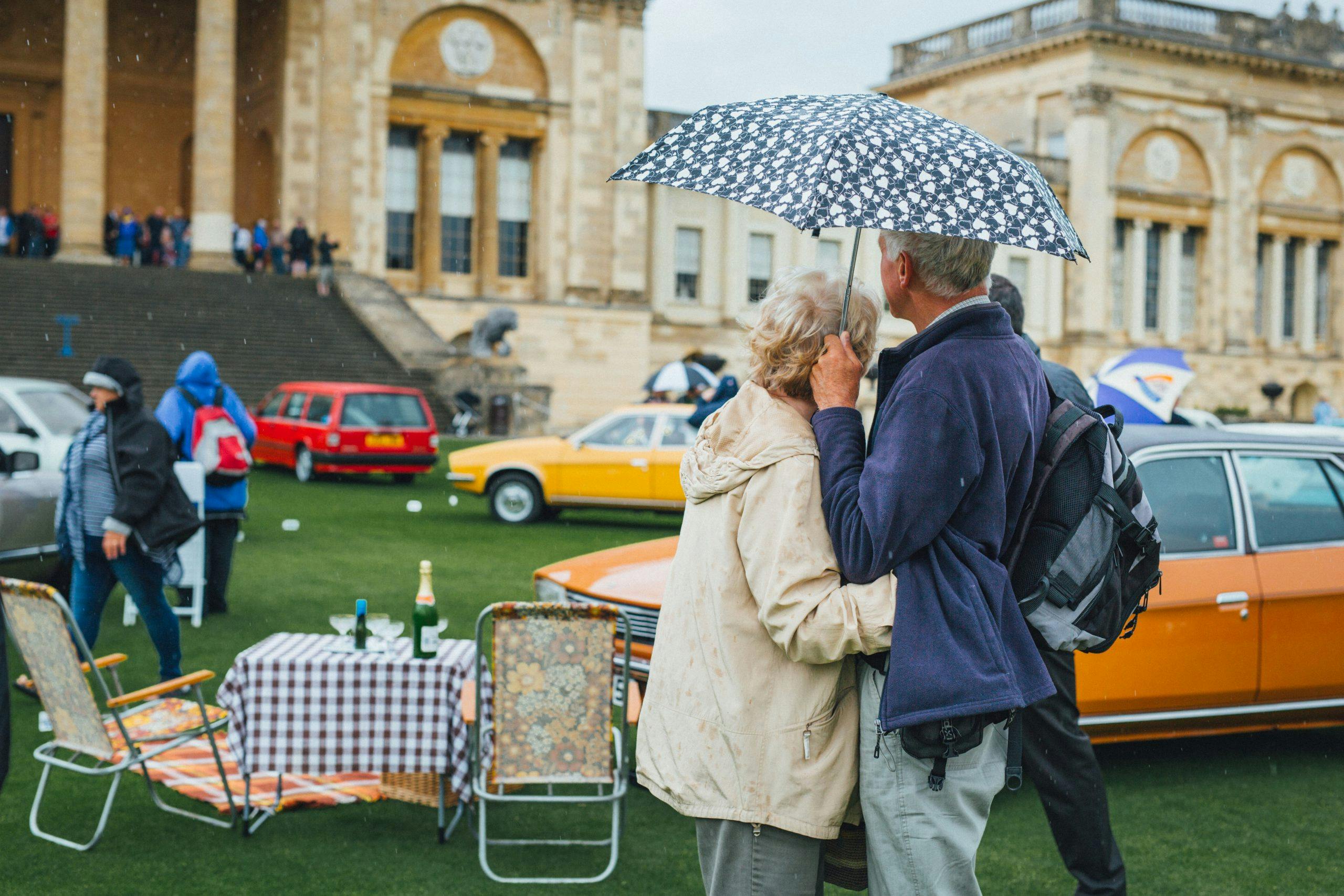 Couple stays dry in the rain at the Festival of the Unexceptional