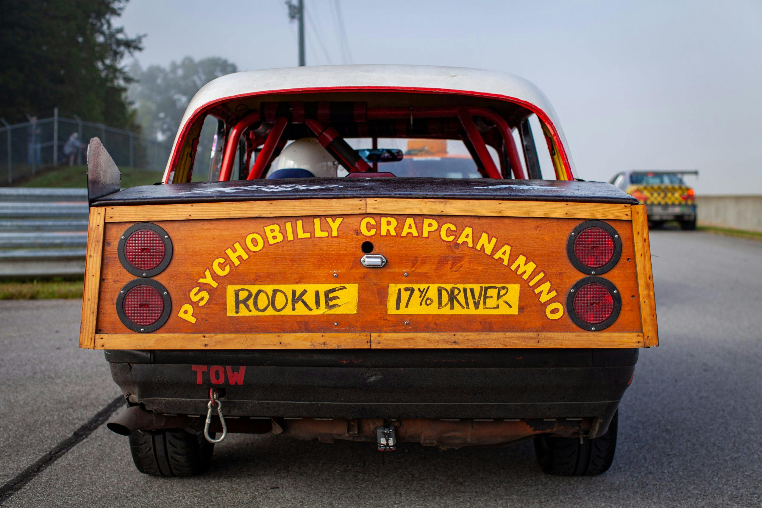 Car's tailgate reads "psychobilly crapcanamino rookie driver" at 24 Hours of Lemons