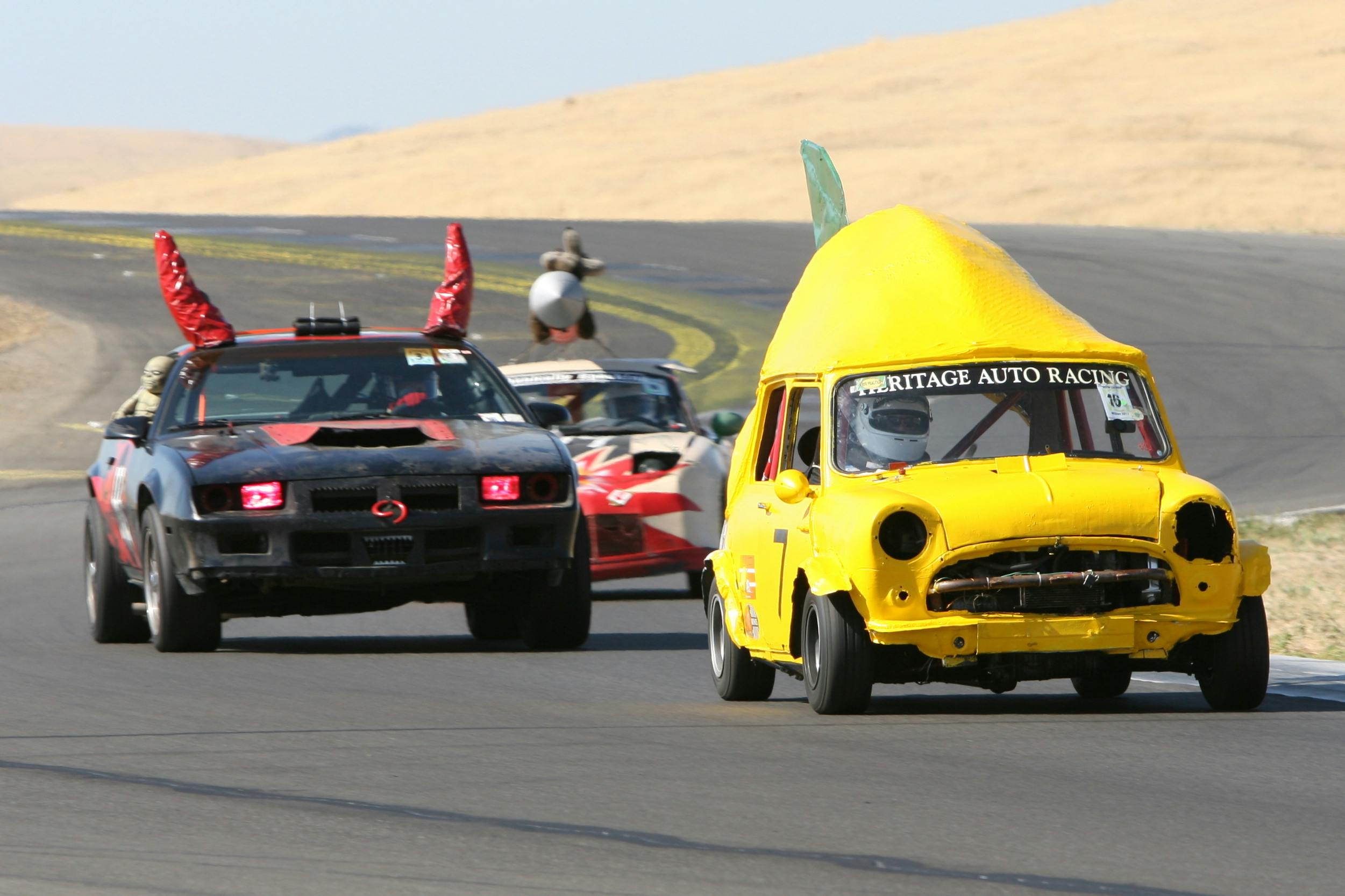 Novelty lemon and devil cars compete in the 24 Hours of Lemons race