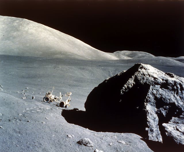 Rover Dwarfed By Giant Rock On Lunar Surface