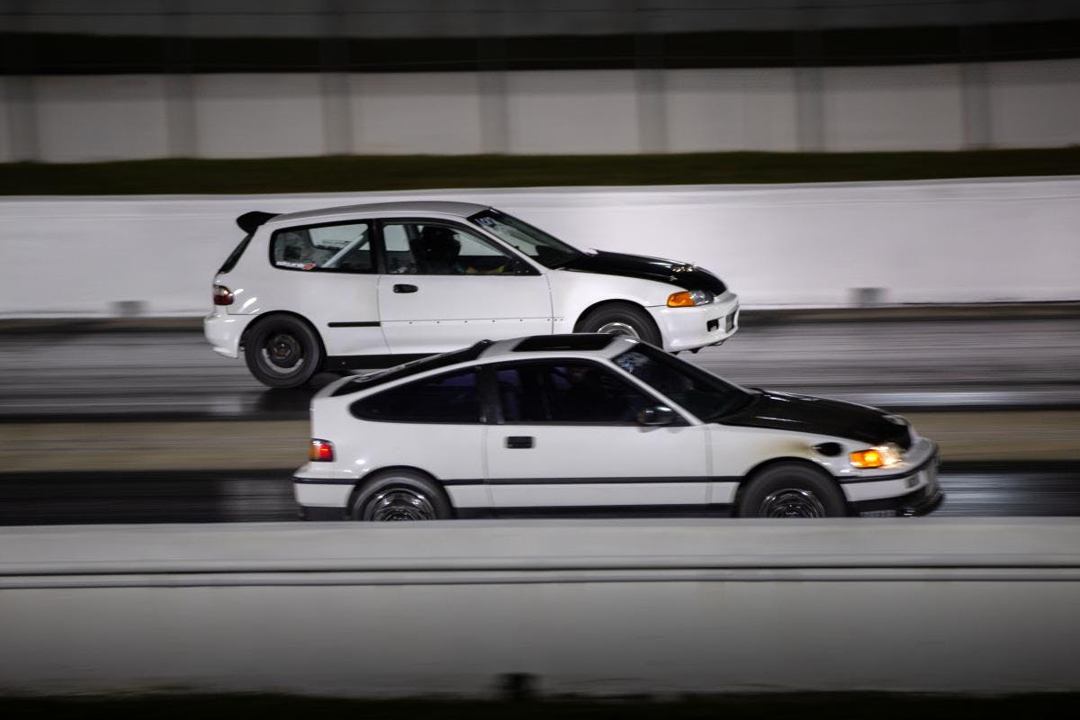 Two cars compete in a roll race