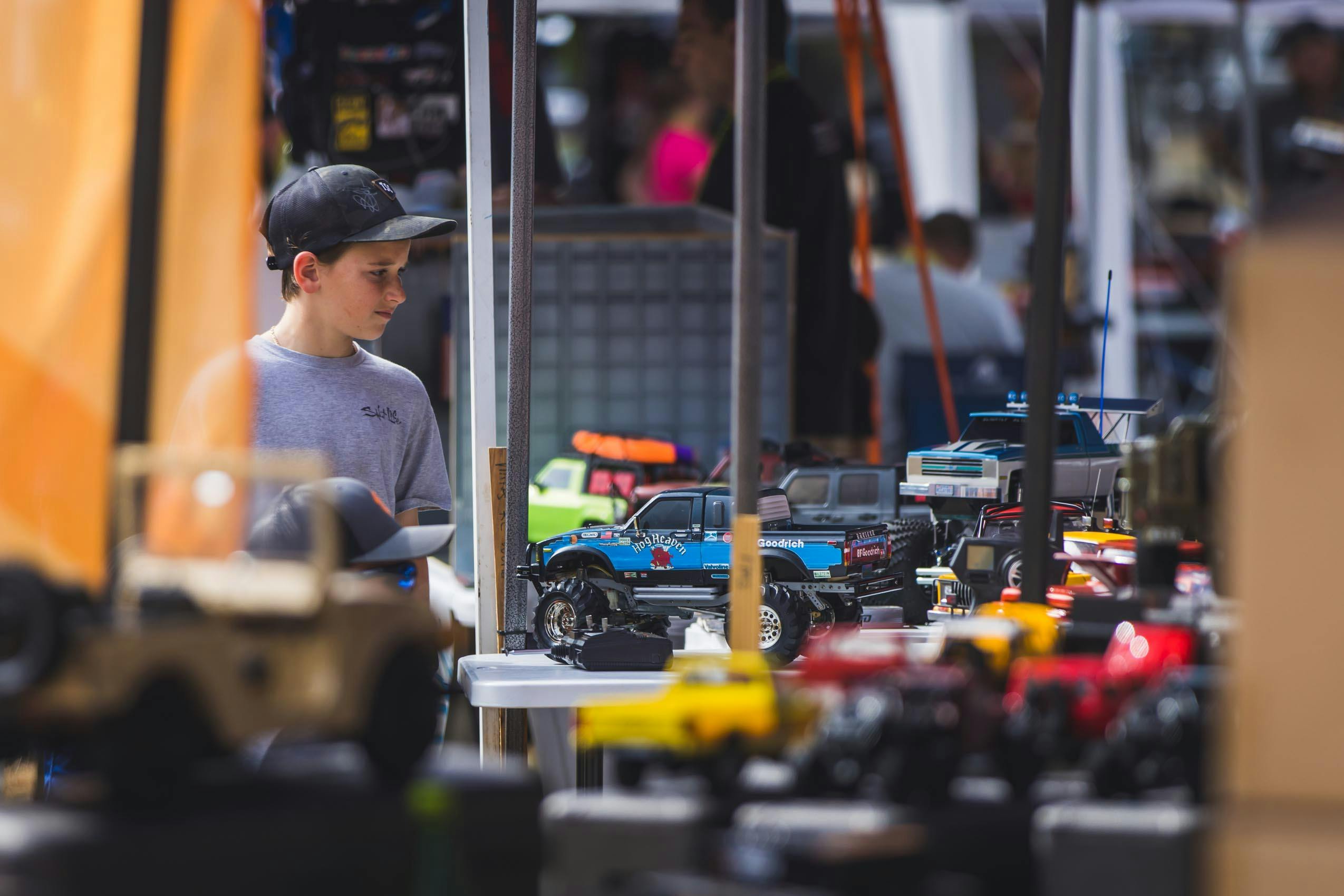 Scale RC Crawlers Kid looking at RCs on table