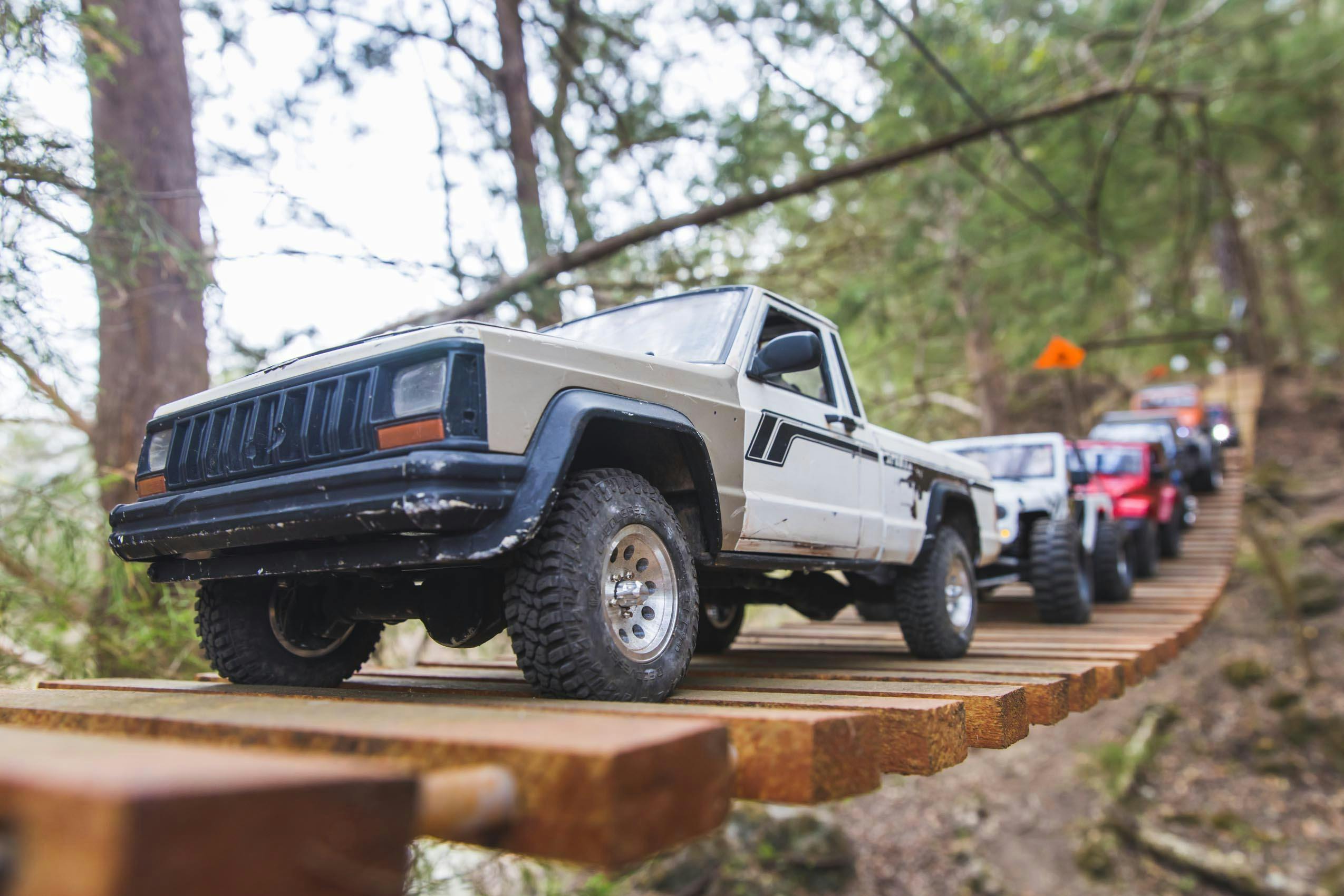Scale RC Crawlers RCs lined up on suspension bridge