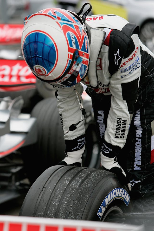 F1 Grand Prix of Hungary Jenson Button inspects Michelin tire