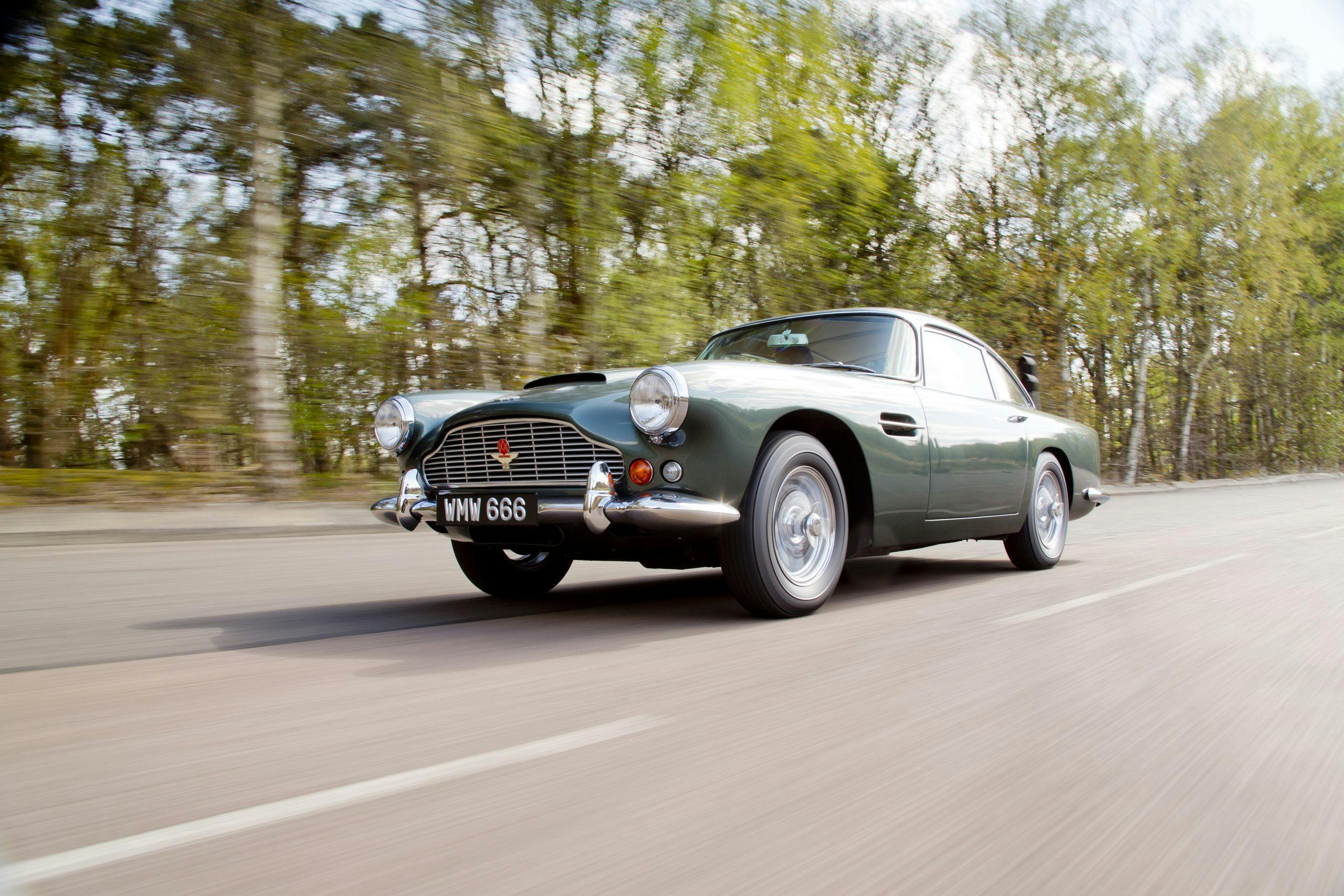 Aston Martin DB4 front three-quarter driving action