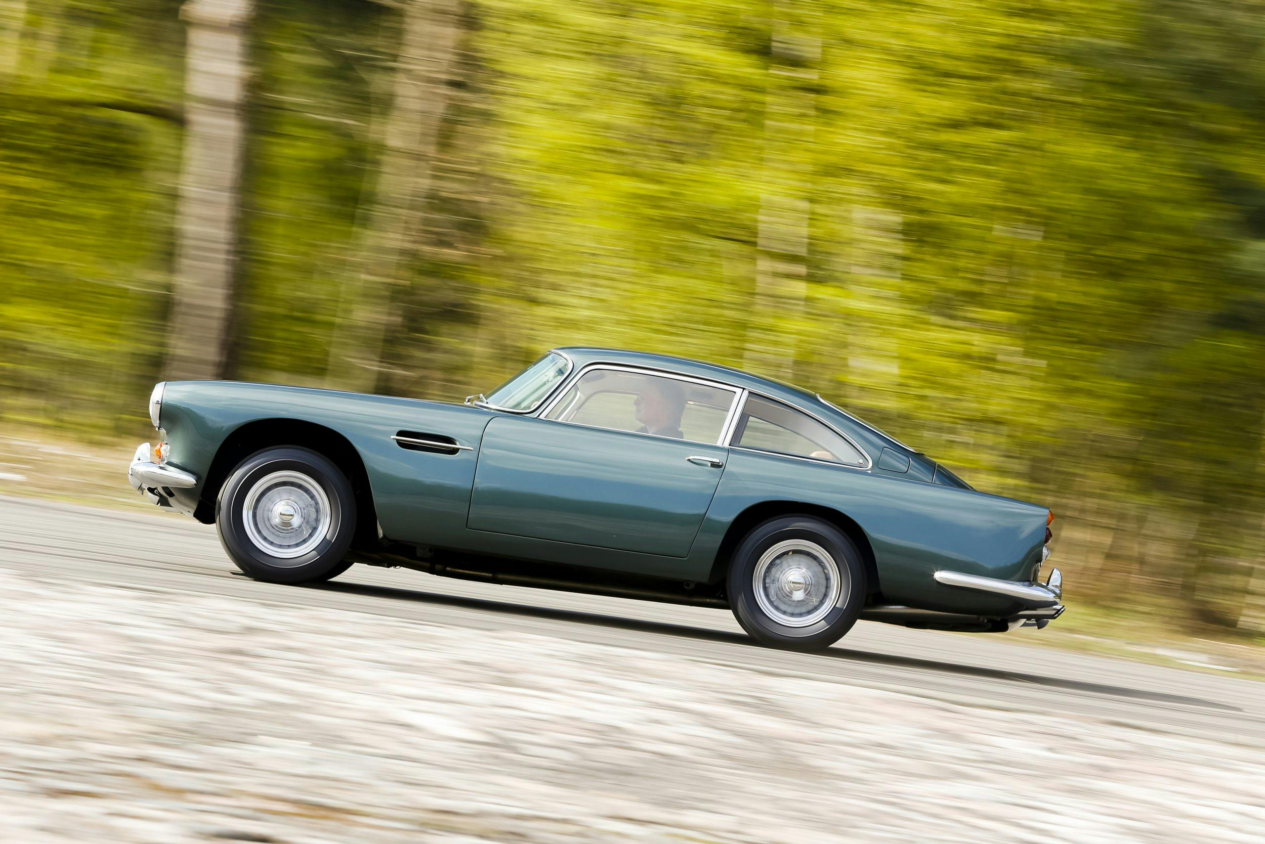 Aston Martin DB4 side view driving action