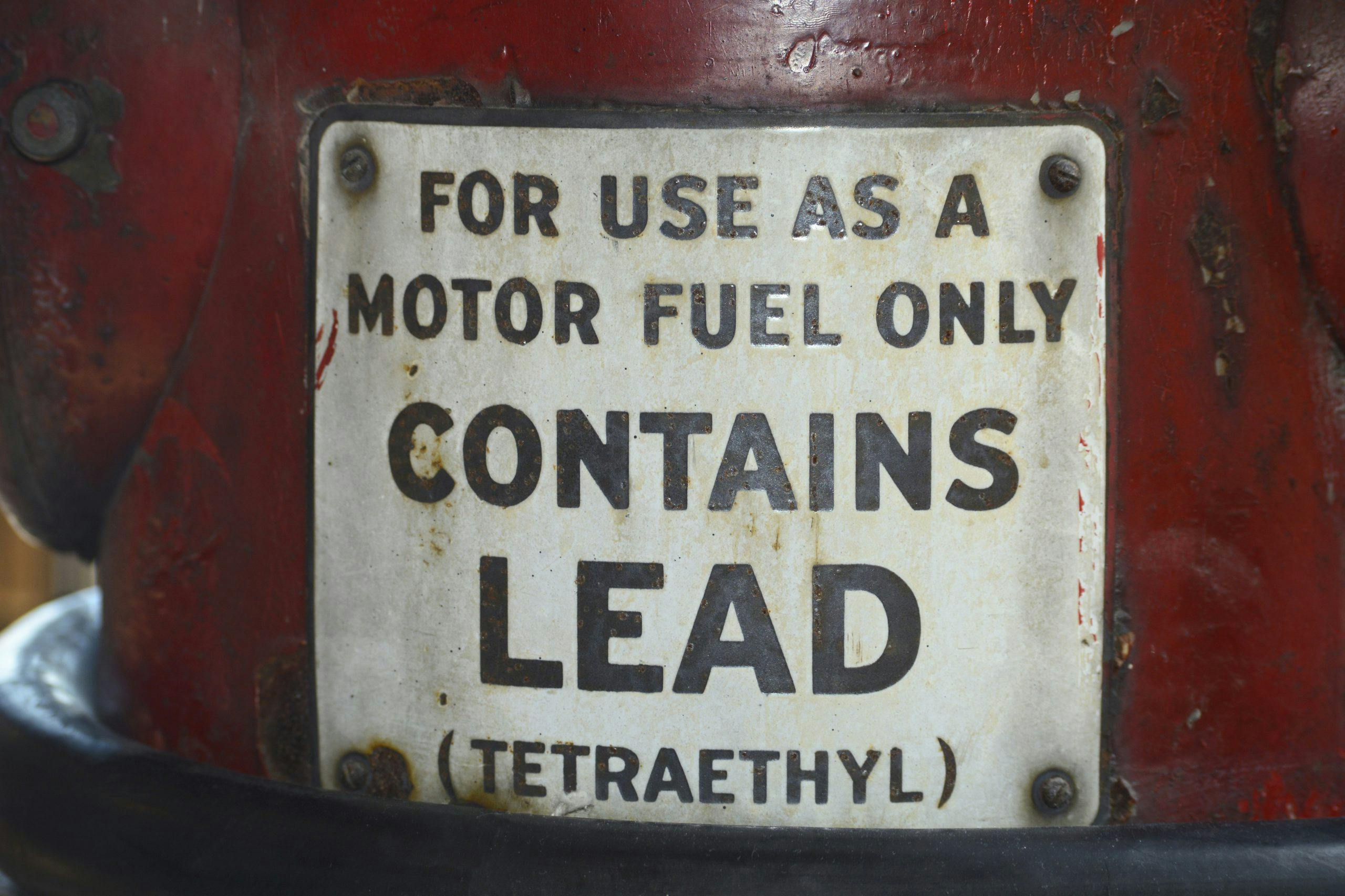 Vintage gasoline pump advises gas contains lead