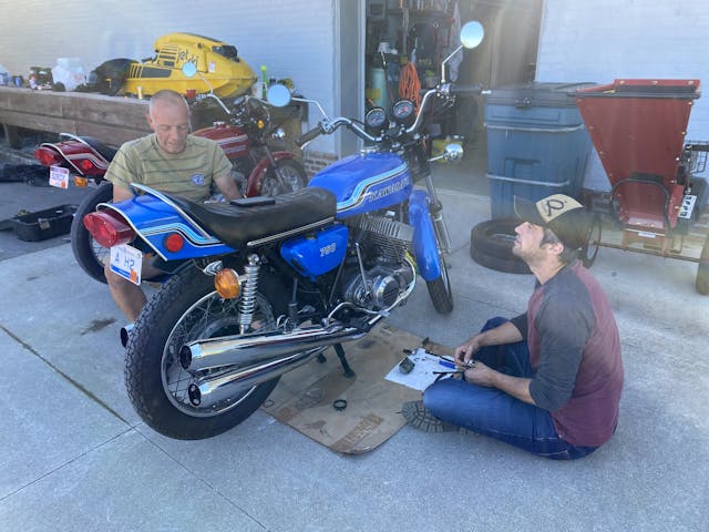 Pair working on vintage kawasaki H2