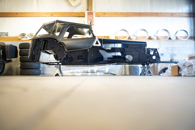 Sam Smith Caterham build low angle body on stands in shop