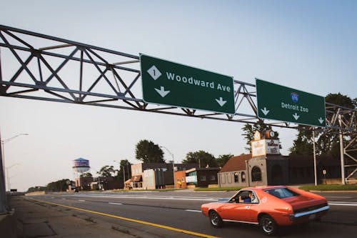 classic muscle car cruises down the highway