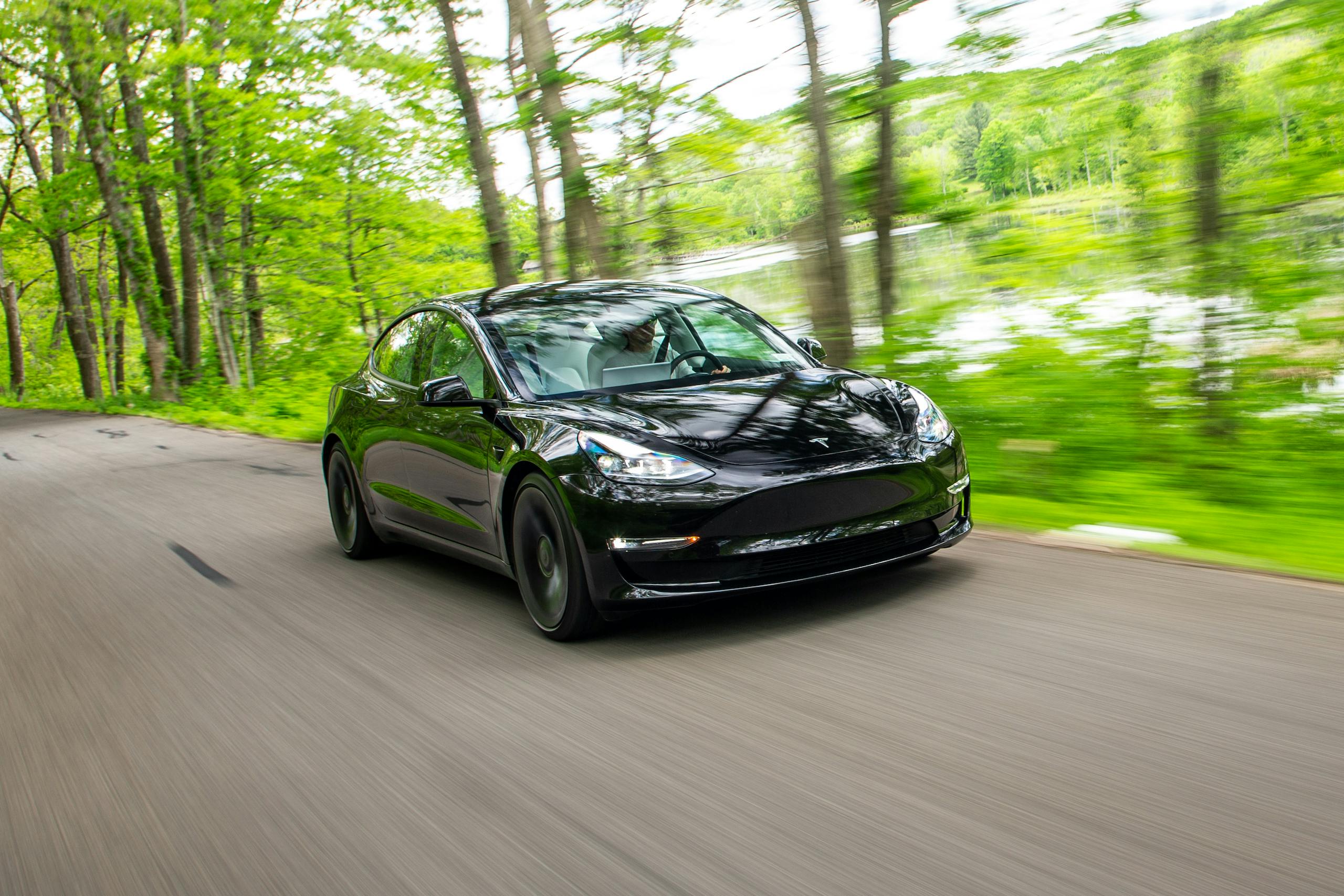 2021 Tesla Model 3 Performance front three-quarter driving action