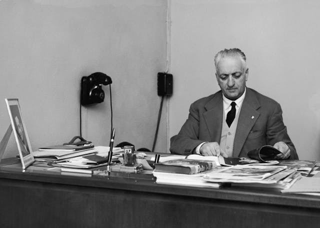 Italian car manufacturer Enzo Ferrari at desk