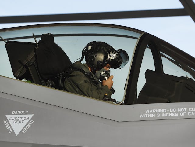 pilot sits in the cockpit of an F-35 fighter jet