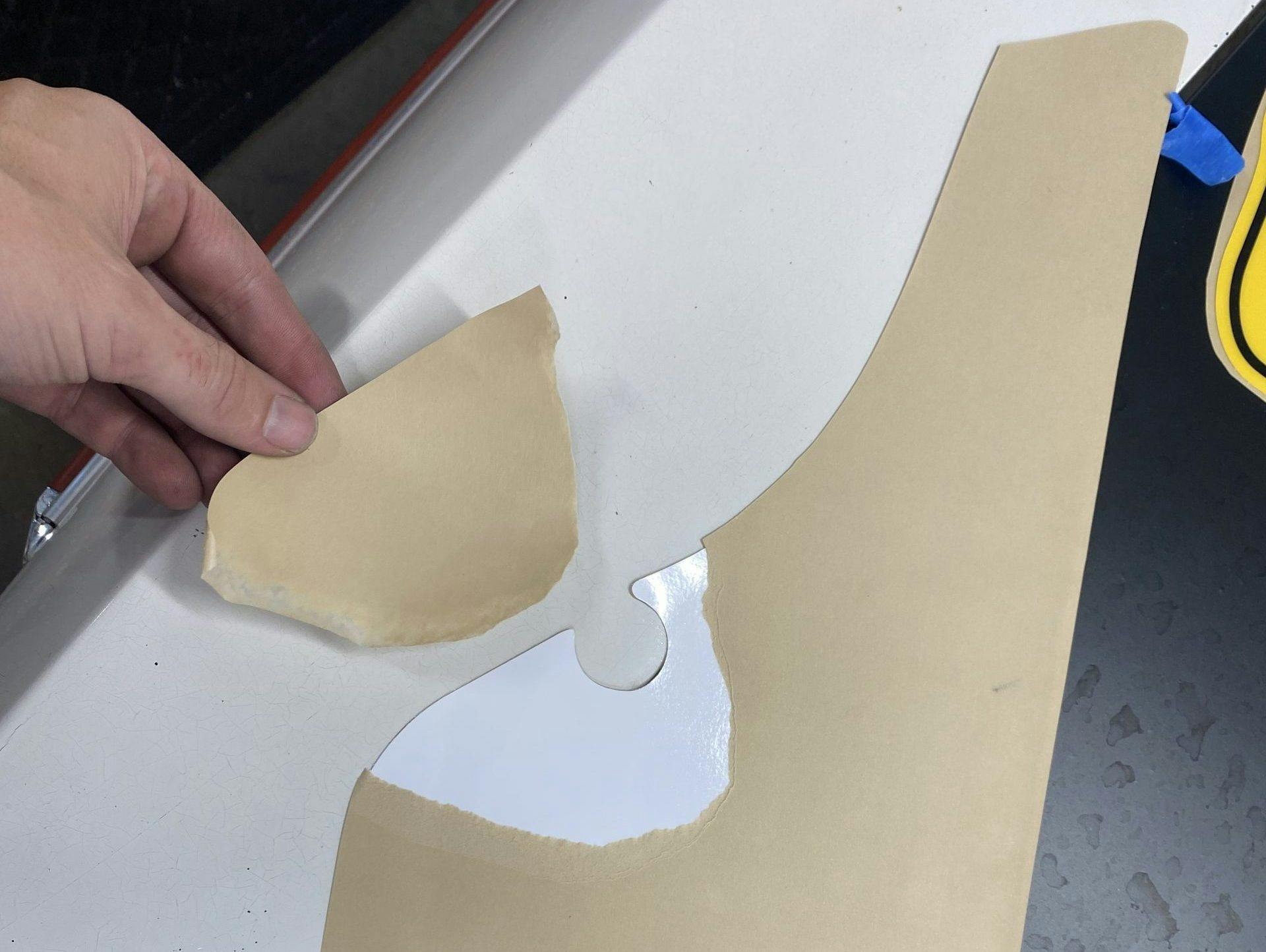 removing a portion of the decal backing