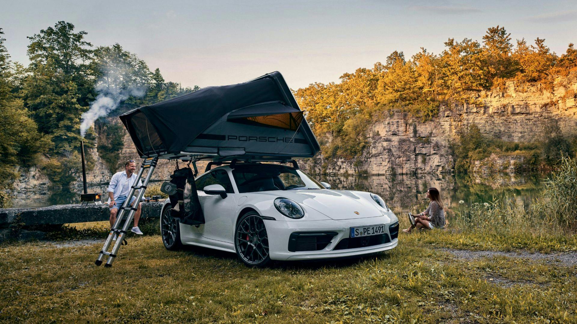 Porsche rooftop tent 911 with tent pitched and ladder out along riverside