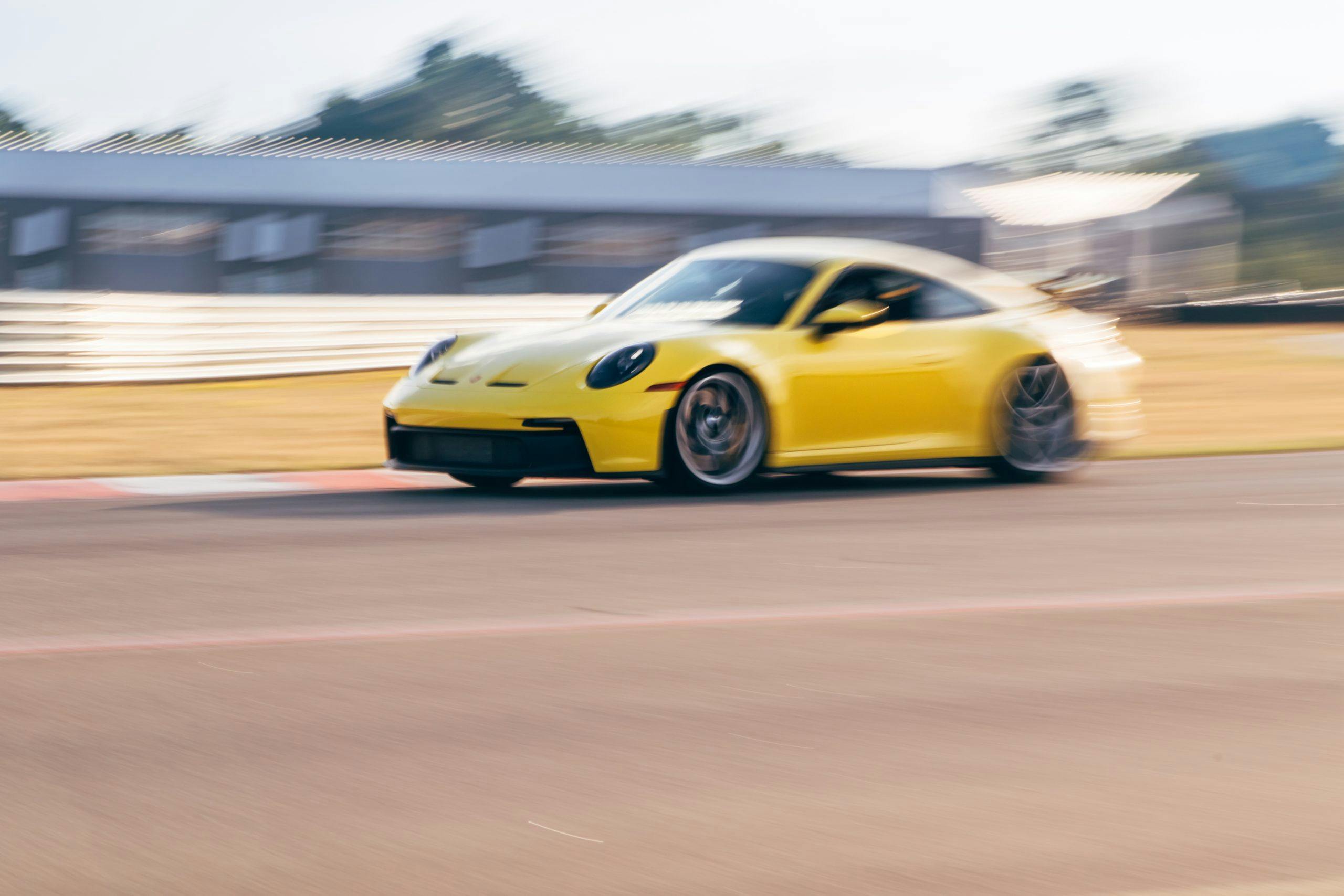 Porsche GT3 front three-quarter dynamic track action motion blur
