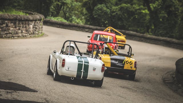 Vintage British roadster race cars action rear