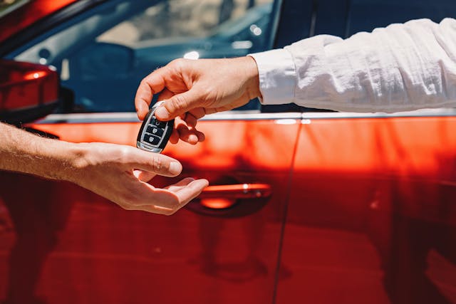 Dealer Giving Car Keys To The New Owner