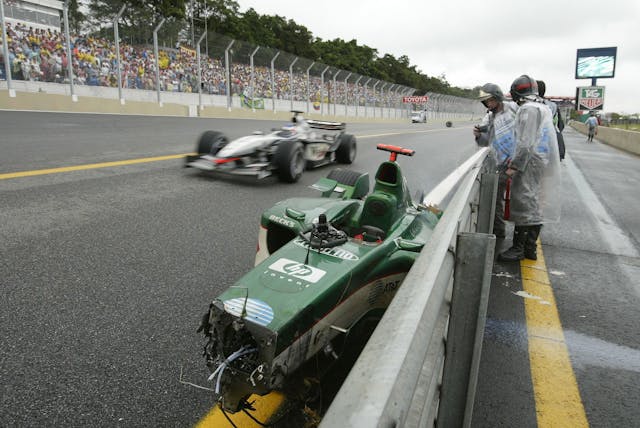 Mark Webber of Australia Jaguar car damage