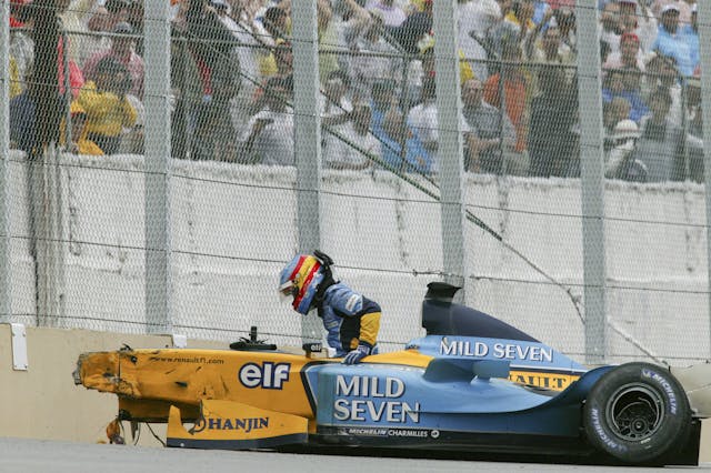 Renault driver Fernando Alonso post crash wreckage exit