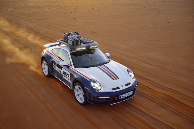 Porsche 911 Dakar front three-quarter high angle off-road action