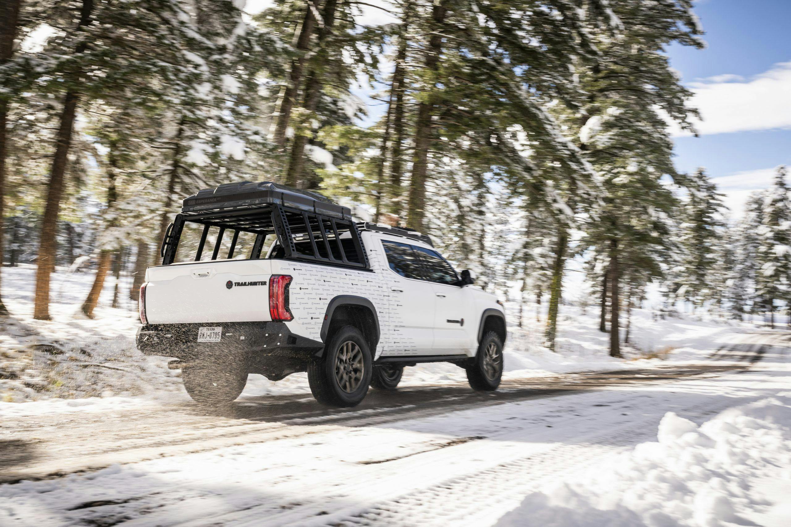 Toyota Trailhunter Concept exterior rear three quarter driving in snow