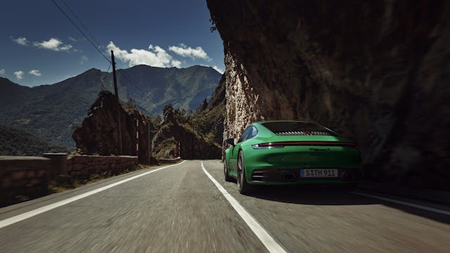 2023 Porsche 911 Carrera T green front rear quarter driving action
